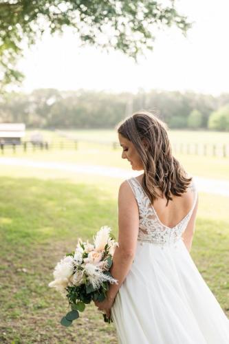 bride looking at bridal bouquet