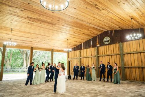 couple's first dance in open air barn venue